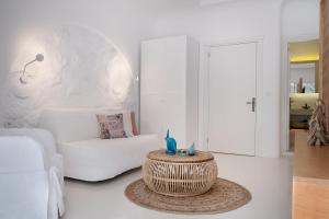 a living room with a white couch and a table at Yasos By The Sea in Çeşme