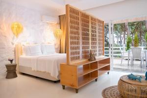 a bedroom with a bed with a wooden headboard at Yasos By The Sea in Çeşme