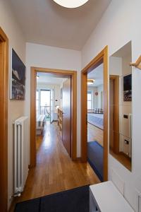 a hallway with a living room and a kitchen at Hike & Bike Home Helena in Arco