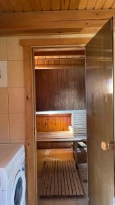 an inside of a sauna with a washing machine at Saulėtekio 12 in Ignalina
