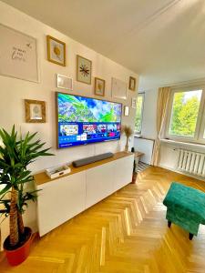 a living room with a large flat screen tv at Luxurious BOHO style apartm. *HOME OFFICE* +Desk in Katowice