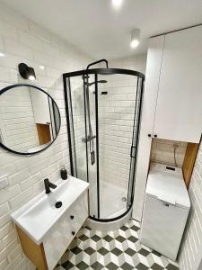 a bathroom with a shower and a sink at Luxurious BOHO style apartm. *HOME OFFICE* +Desk in Katowice