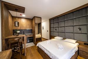 una camera con letto e scrivania e una cucina di Apartments Tulip Podgorica a Podgorica