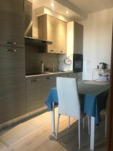 a kitchen with a blue table and a white chair at VASTO centro Alloggio 1-2-3 in Vasto