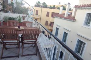 a balcony with a table and chairs on a balcony at Plaka's Heart in Athens