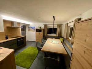 eine Küche mit Tisch und Stühlen in einem Zimmer in der Unterkunft Chalet Urscheler in Oberleite