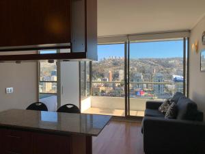 a living room with a view of a city at Apartemento tres Norte in Viña del Mar