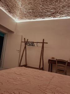 a bedroom with a bed and a brick wall at VadoLibera House in LʼAquila +28 photos