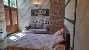 a bedroom with a bed and a couch in a room at Sea View Marina Dinevi Apartments - Tryavna Beach in Sveti Vlas