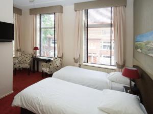 En eller flere senge i et værelse på Hotel Kuiperduin
