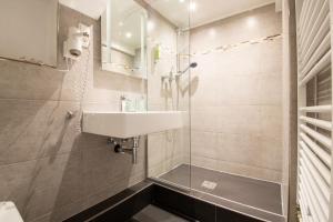 a bathroom with a sink and a shower at AMADEA - Cityhotel Salzburg in Salzburg +34 photos