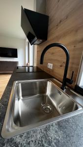 a kitchen sink with a faucet in a kitchen at Studio11 in Neustift im Stubaital