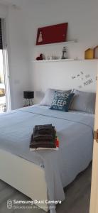 a white bed with a pile of towels on it at Ca Na Xisca in Felanitx +76 photos