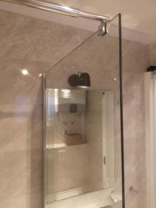 a shower with an apple on the top of it at Apartments Frenkie in Komiža