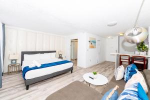 a bedroom with a bed and a living room at Sobe Apartments in Miami Beach