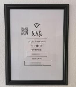 a framed picture of a certificate in a picture frame at SKY INN - nahe Messe contactless check in in Hannover
