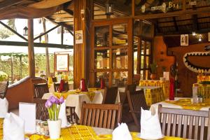 a restaurant with tables and chairs with flowers on them at Paloma Hotel Ring Road in Accra