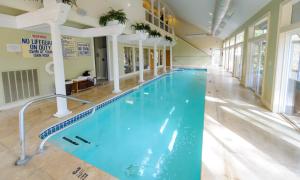 a large swimming pool in a building with a blue pool at Inn at Crestwood in Boone