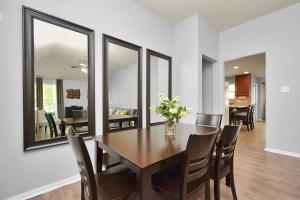 a dining room with a wooden table and mirrors at Early Green Home Sleeps 6 Yard King Suite in Houston