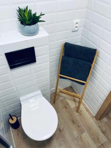 a bathroom with a toilet and a chair at ne-doma in Chomutov