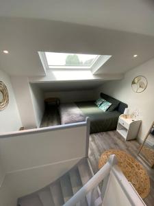 a attic room with a bed and a skylight at L'Emile Zola in Saint-Quentin