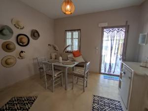 a kitchen and dining room with a table and chairs at Pallos studio in Órmos Koumaíïkon