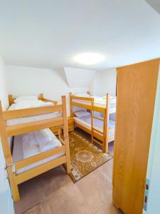 a room with three bunk beds and a door at Oaza Mira Hotel & Resort-فندق ومنتجع واحة الهدوء in Vlasic