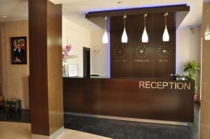 a reception desk in a hotel lobby with lights at Suites Hotel Omeya in Martil