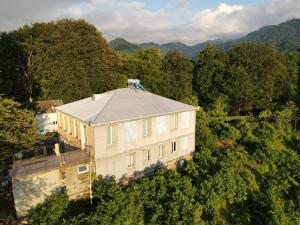 an aerial view of a large building in the forest at Guest House MARTA in Kobuleti