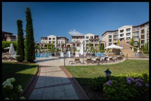 a park with chairs and umbrellas in a resort at Sozopol studio deluxe Green life resort in Sozopol