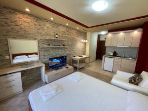 a large living room with a white bed and a kitchen at Sozopol studio deluxe Green life resort in Sozopol