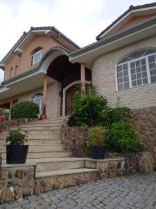 a house with stairs and plants in front of it at Casa Travessa da Quinta in Mondim de Basto