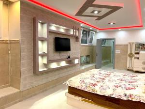 - une chambre avec un lit et une télévision murale dans l'établissement Villa nador, à Nador
