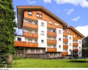 a tall building with balconies on the side of it at Neve e Sole in Selva di Val Gardena