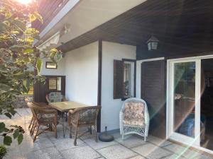 porche con mesa y sillas en el patio en COSY VINTAGE HOUSE, en Bled