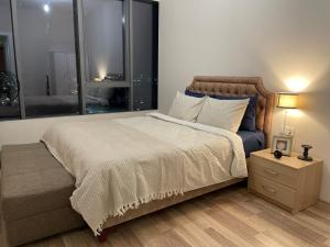 1 dormitorio con 1 cama grande, mesita de noche y ventanas en Kozza Park, next to Akbati Shopping Mall and Tennis Academy, en Estambul