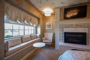 a living room with a couch and a fireplace at Mill Rose Inn in Half Moon Bay