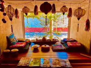 a room with pillows and a table with a window at Mousai Hotel Boutique in Capilla del Monte