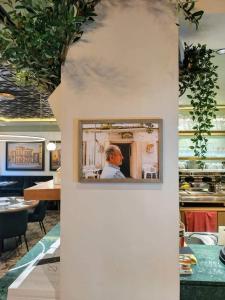 a man in a mirror on a wall in a restaurant at Hotel Ariston in Lahnstein