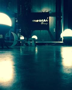 a dark room with a table and chairs and lights at Mousai Hotel Boutique in Capilla del Monte