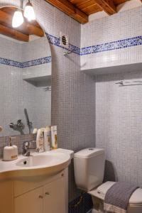 y baño con aseo y lavamanos. en Floral Villa with marvelous view to Mykonos town, en Mykonos ciudad