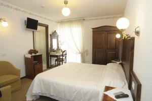 Postel nebo postele na pokoji v ubytování Hotel Mazzoleni + 35 fotografií