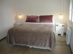 a bedroom with a large bed with two pillows at Mousai Hotel Boutique in Capilla del Monte +72 photos