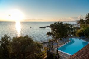 a view of a swimming pool and the ocean at Dimitra Studios in Benitses