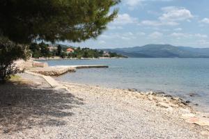a rocky shore of a large body of water at Apartments with a parking space Maslenica, Novigrad - 11089 in Maslenica