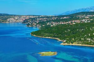 an island in the middle of a large body of water at Apartments with parking space Maslenica, Novigrad - 11089 in Maslenica
