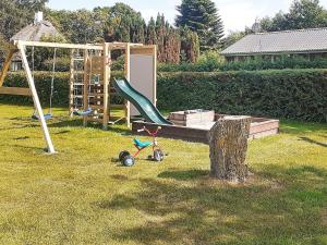a playground with a slide and a swing at Holiday home Nordborg XIII in Nordborg