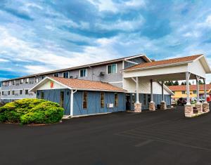 a large building with a parking lot in front of it at Super 8 by Wyndham Missoula/Brooks Street in Missoula