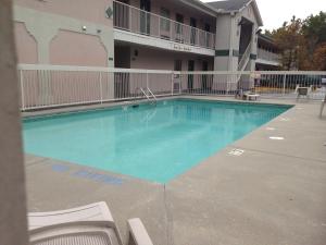 a large swimming pool in front of a building at Country Hearth Inn & Suites Augusta in Augusta