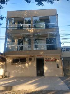 an apartment building with a door in front of it at Pousada Avenida in Teixeira de Freitas